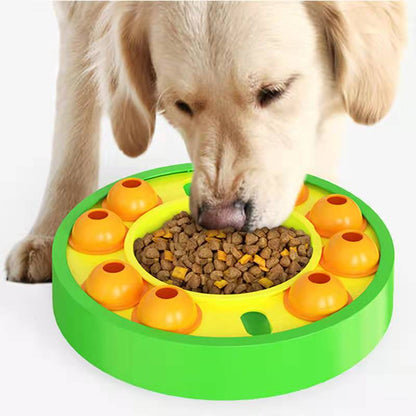 Dog interacting with a green and orange puzzle toy filled with kibble.