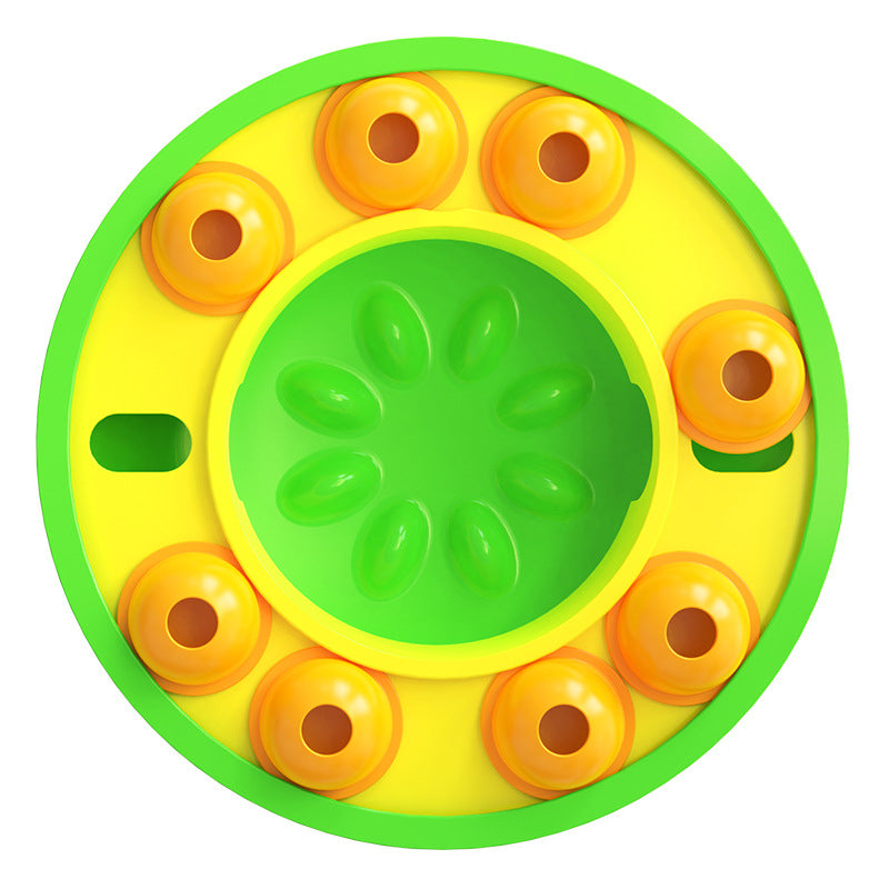 Round yellow and green toy with orange circular elements on a white background