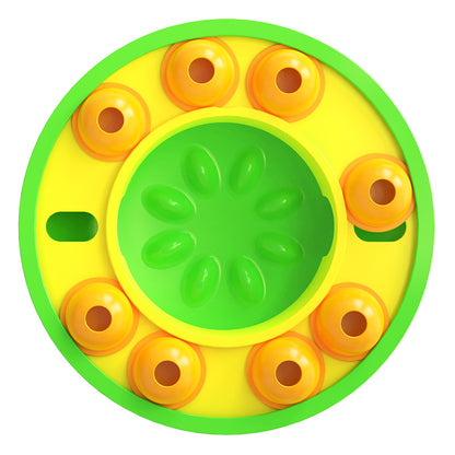 Round yellow and green toy with orange circular elements on a white background