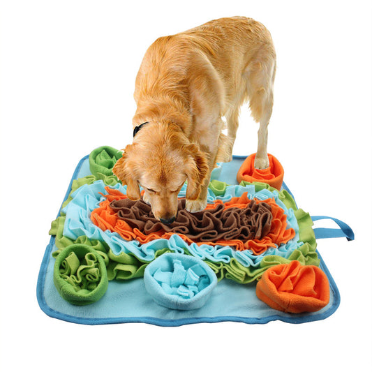 Dog interacting with a colorful snuffle mat on a white background