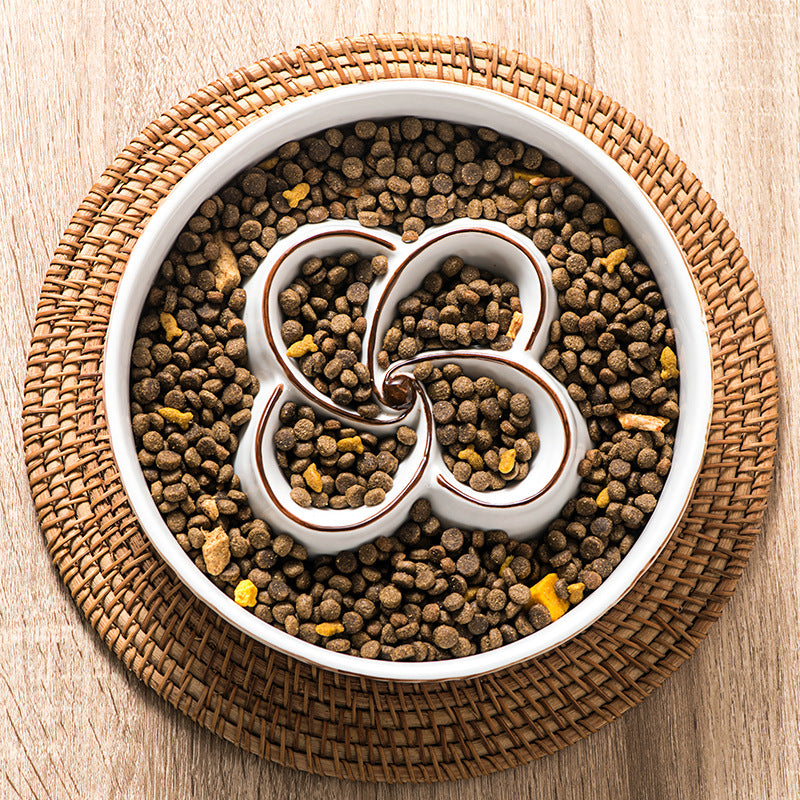 White bowl filled with pet food on a woven placemat