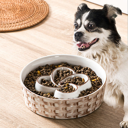 Dog next to a large bowl of dog food on a wooden floor